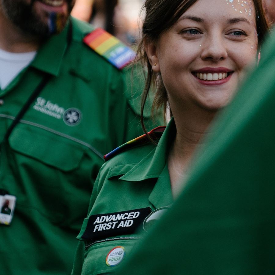 The face of an Advanced First Aid volunteer with glitter on their face, looking to the side, smiling. The face of an Advanced First Aid volunteer with glitter on their face, looking to the side, smiling.