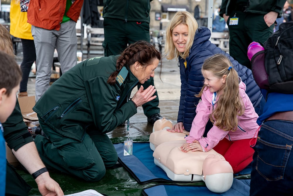 A young girl learning about CPR.